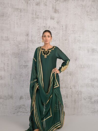 A woman wearing a green and gold dress