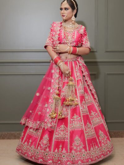 Elegant Indian bride wearing a vibrant pink lehenga, adorned with intricate embroidery, showcasing cultural heritage.