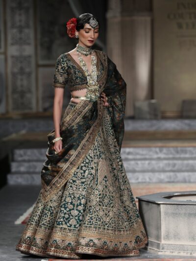 Photo by RAJESH KUMAR VERMA Stunning model showcases traditional Indian bridal wear during a fashion show.