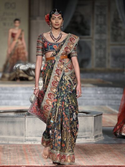 A fashion model in traditional attire on the runway in New Delhi, India.