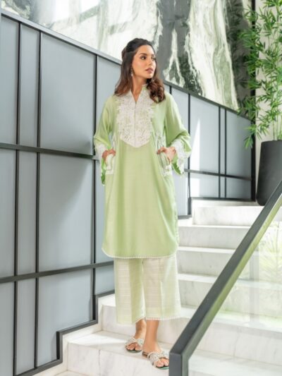 A woman in a green outfit standing on some stairs