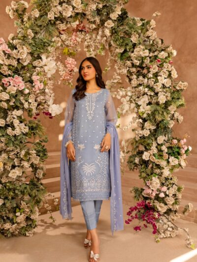 A woman standing in front of a floral archway
