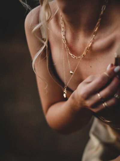 woman in white tank top wearing silver necklace