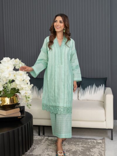 A woman standing in a living room next to a couch