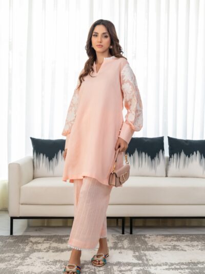A woman standing in front of a couch in a living room