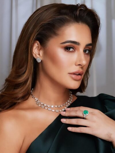 A woman wearing a green dress and a necklace