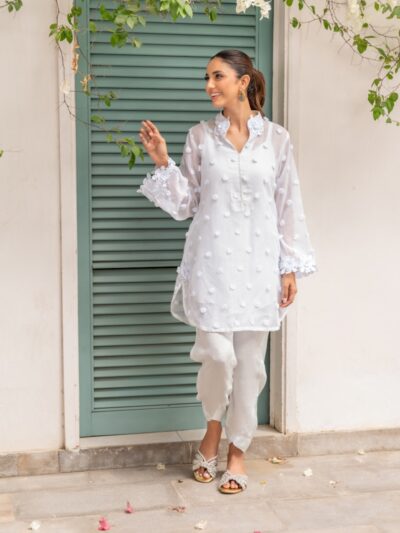 A woman standing in front of a green door