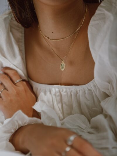 woman in white off shoulder dress wearing silver necklace